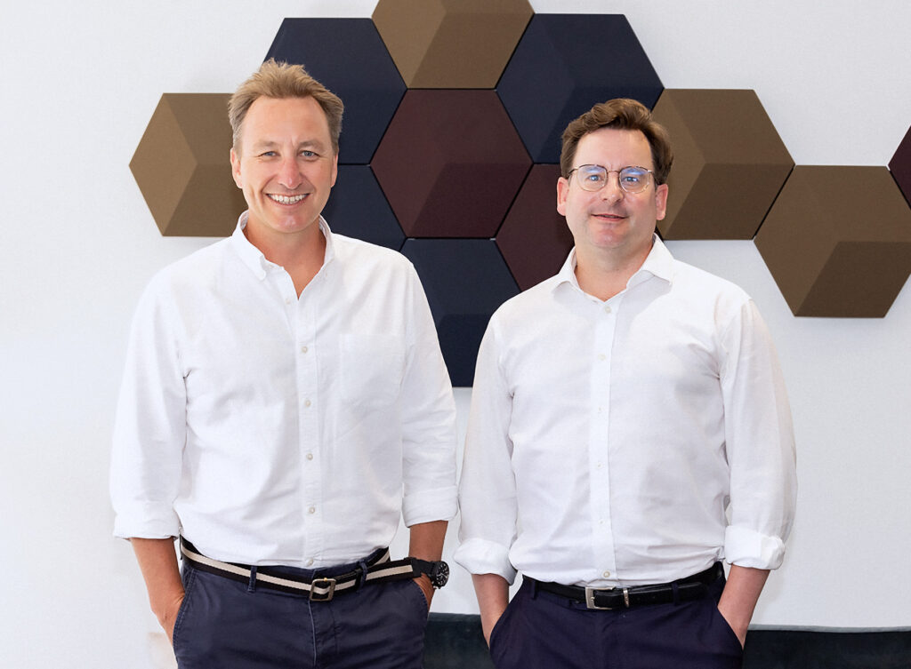 InSolve directors standing in front of wall art